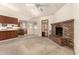 Open-concept living room featuring tile flooring, a fireplace and ceiling fan at 136 E San Angelo Ave, Gilbert, AZ 85234