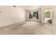 Bright living room featuring a large window and neutral carpeting at 136 E San Angelo Ave, Gilbert, AZ 85234