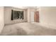 Bright living room featuring a large window and neutral carpeting at 136 E San Angelo Ave, Gilbert, AZ 85234