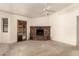 Living room featuring a fireplace and a ceiling fan at 136 E San Angelo Ave, Gilbert, AZ 85234