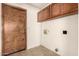 Functional mud room featuring storage cabinets and access to the outside at 136 E San Angelo Ave, Gilbert, AZ 85234