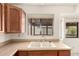 A traditional sink and wood cabinets complement this kitchen at 136 E San Angelo Ave, Gilbert, AZ 85234