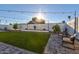Beautiful backyard featuring green turf, pavers, string lights and desert landscaping at 13614 N 38Th Pl, Phoenix, AZ 85032