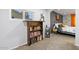 Bedroom view highlighting built-in bookshelf and neutral decor with a peek into the Primary bedroom at 13614 N 38Th Pl, Phoenix, AZ 85032