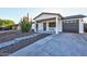 Charming home featuring a covered front porch, low maintenance desert landscaping and attached garage at 13614 N 38Th Pl, Phoenix, AZ 85032