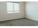 Bright bedroom featuring neutral walls, carpet floors, and a window at 1623 E Hidalgo St, Apache Junction, AZ 85119