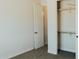 Bedroom featuring carpet flooring, open closet, and neutral walls at 1623 E Hidalgo St, Apache Junction, AZ 85119
