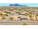 Expansive aerial view showcases the neighborhood and surrounding desert landscape with mountain views at 1623 E Hidalgo St, Apache Junction, AZ 85119