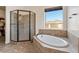 Bathroom with a soaking tub, enclosed shower, and view of the outdoors at 1623 E Hidalgo St, Apache Junction, AZ 85119