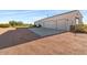 The home has a multiple car garage and desert landscaping at 1623 E Hidalgo St, Apache Junction, AZ 85119