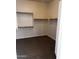This walk-in closet features wood shelving and carpeted floors at 1623 E Hidalgo St, Apache Junction, AZ 85119