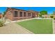 Expansive backyard with lush green lawn, pavers, and covered patio at 16259 W Papago St, Goodyear, AZ 85338