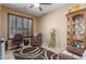 Cozy bedroom features a large window, ceiling fan, and comfortable seating area at 16259 W Papago St, Goodyear, AZ 85338