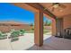 Relaxing covered patio with stylish outdoor seating and a view of the backyard at 16259 W Papago St, Goodyear, AZ 85338