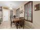 Dining room with a wooden table, chairs, and natural light from a window at 16259 W Papago St, Goodyear, AZ 85338