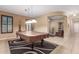 Spacious game room with a billiard table, neutral walls, and an adjacent living area with an arched entry at 16259 W Papago St, Goodyear, AZ 85338