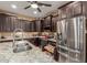 Modern kitchen features stainless steel appliances, granite countertops, and ample dark wood cabinetry at 16259 W Papago St, Goodyear, AZ 85338