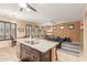 Open kitchen with granite island, seating, and a seamless transition to the living area at 16259 W Papago St, Goodyear, AZ 85338