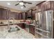 This contemporary kitchen features stainless steel appliances, granite countertops, and custom dark wood cabinetry at 16259 W Papago St, Goodyear, AZ 85338
