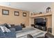 Inviting living room with a large TV, comfortable seating, and stylish decor at 16259 W Papago St, Goodyear, AZ 85338