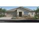 Charming single-story home with a two-car garage, stone accents, and manicured front yard at 17175 W Blue Sky Dr, Surprise, AZ 85387