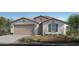 Charming single-story home showcasing a desert landscape, tile roof, and a two-car garage at 18188 W Sonora St, Goodyear, AZ 85338