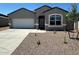 Charming single-story home with a well-maintained front yard and a two-car garage at 18331 W Hackamore Dr, Wittmann, AZ 85361