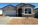 Charming single-story home featuring a two-car garage, neutral stucco, and a well-manicured yard at 18331 W Hackamore Dr, Wittmann, AZ 85361