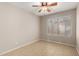 Bedroom with a ceiling fan and natural light from a window, and light tile floors at 19601 N 7Th St # 1022, Phoenix, AZ 85024
