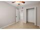 Bedroom featuring a closet with sliding doors, neutral paint, and light tile flooring at 19601 N 7Th St # 1022, Phoenix, AZ 85024