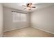 Neutral bedroom featuring ceiling fan, tiled floors, and a bright window with blinds at 19601 N 7Th St # 1022, Phoenix, AZ 85024