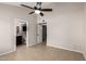 Bedroom with a view to the bathroom; neutral paint, light tile flooring and a view of a closet at 19601 N 7Th St # 1022, Phoenix, AZ 85024