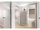 Hallway view showcasing access to a tiled bathroom and a bedroom with a ceiling fan at 19601 N 7Th St # 1022, Phoenix, AZ 85024