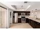 This kitchen features dark wood cabinets, stainless steel appliances, and light-colored countertops at 19601 N 7Th St # 1022, Phoenix, AZ 85024