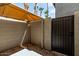 Enclosed patio space with gravel, cinder block walls, sun shade, and metal gate at 19601 N 7Th St # 1022, Phoenix, AZ 85024