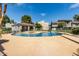 Community pool view features a lounge area, sun-soaked deck, and mature landscaping at 19601 N 7Th St # 1022, Phoenix, AZ 85024