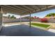 Spacious backyard featuring a covered patio, lush green lawn, and privacy fence at 2233 W Oraibi Dr, Phoenix, AZ 85027