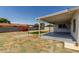 Backyard with covered patio, low-maintenance landscaping, and privacy fence at 2233 W Oraibi Dr, Phoenix, AZ 85027