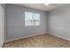 This bright bedroom with tile flooring features a ceiling fan and a window to let the sun shine in at 2233 W Oraibi Dr, Phoenix, AZ 85027