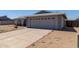 Home exterior featuring a two car garage and low-maintenance landscaping at 2233 W Oraibi Dr, Phoenix, AZ 85027