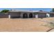 Charming home with arched entryway, desert landscaping, gray roof and neutral colored paint at 2233 W Oraibi Dr, Phoenix, AZ 85027