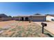 Charming home with arched entryway, two-car garage, desert landscaping, and concrete driveway at 2233 W Oraibi Dr, Phoenix, AZ 85027