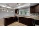 Well-appointed kitchen with dark wood cabinets, tiled floors, and stainless steel appliances at 2233 W Oraibi Dr, Phoenix, AZ 85027