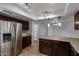 Spacious kitchen area with dark cabinets, stainless appliances, and convenient breakfast bar at 2233 W Oraibi Dr, Phoenix, AZ 85027