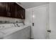 Laundry room with washer, dryer and overhead cabinets at 2233 W Oraibi Dr, Phoenix, AZ 85027