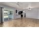 Spacious living room with tiled floors, ceiling fan, and sliding glass doors to the patio at 2233 W Oraibi Dr, Phoenix, AZ 85027