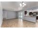 Open concept living room and kitchen space features tile floors and natural light at 2233 W Oraibi Dr, Phoenix, AZ 85027