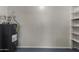 Utility room offering a water heater and shelving unit at 2233 W Oraibi Dr, Phoenix, AZ 85027