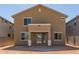 Rear exterior of the house with sliding glass doors to backyard at 22863 N 183Rd Dr, Surprise, AZ 85387
