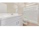 Clean bathroom showcasing double sinks, white cabinetry, and a modern glass-enclosed shower at 22863 N 183Rd Dr, Surprise, AZ 85387